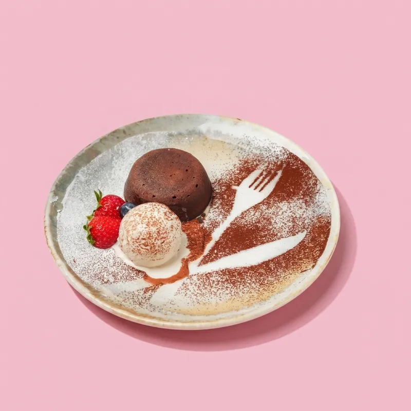 Freshly baked Molten Lava Cake with cascading Belgian chocolate & artisanal vanilla bean gelato. 🍫🔥